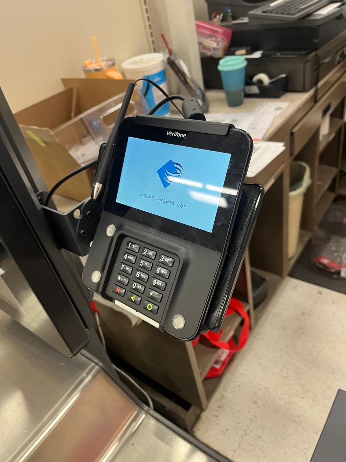 Payment terminal on an articulated counter mount at a retail service desk